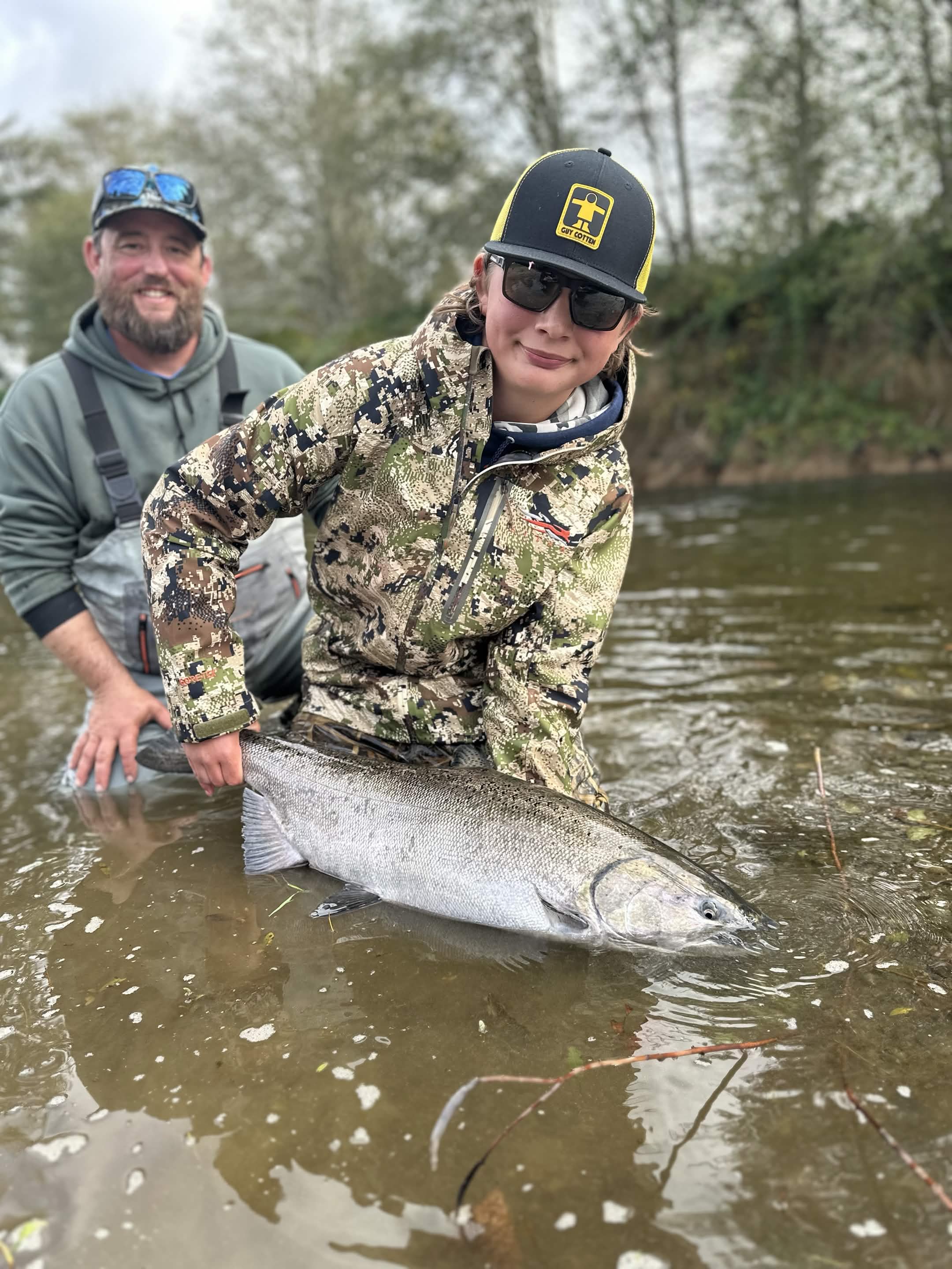 Angler holding a trophy king salmon on a Washington river