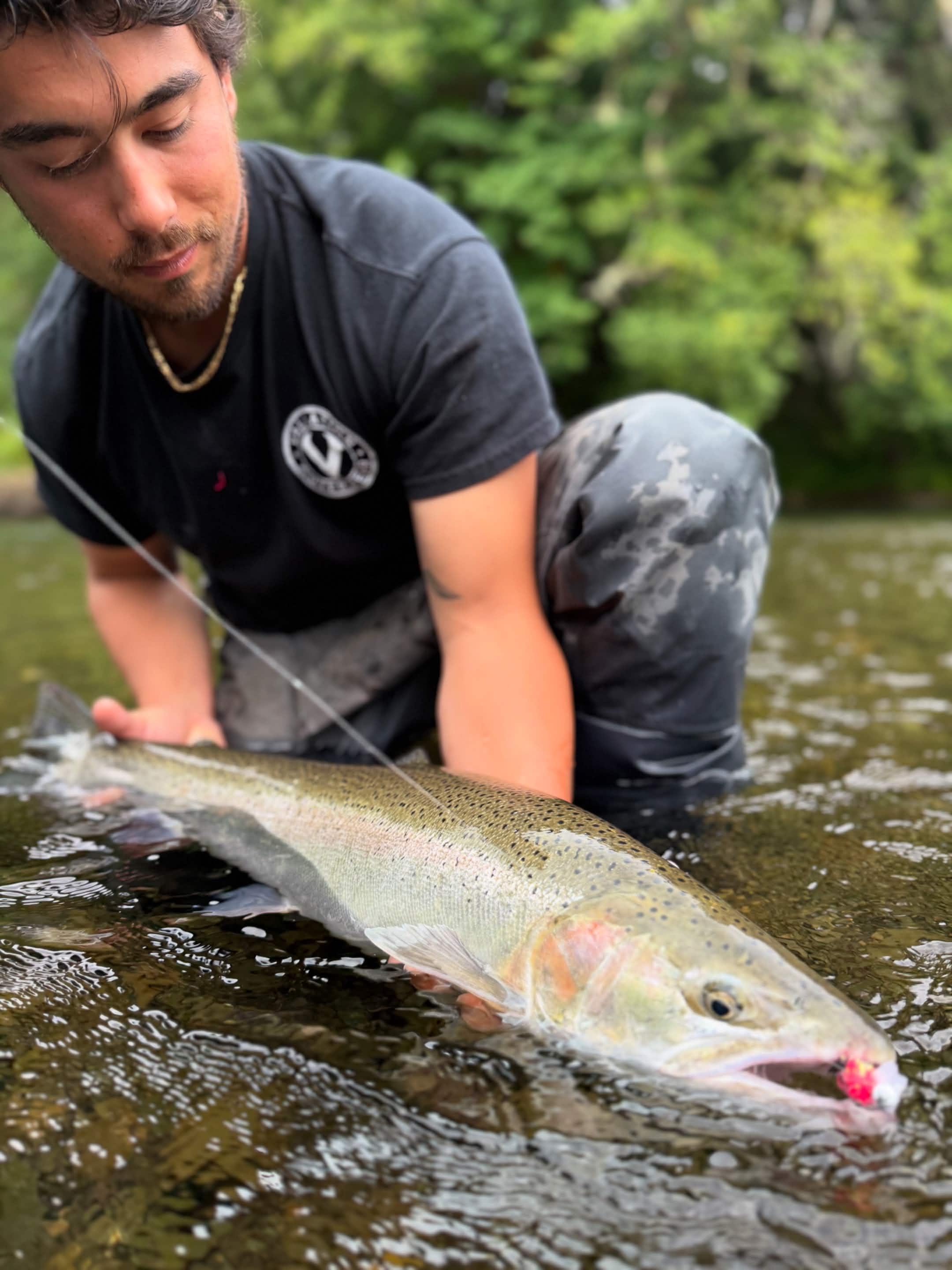 Angler holding a fish on a Washington river