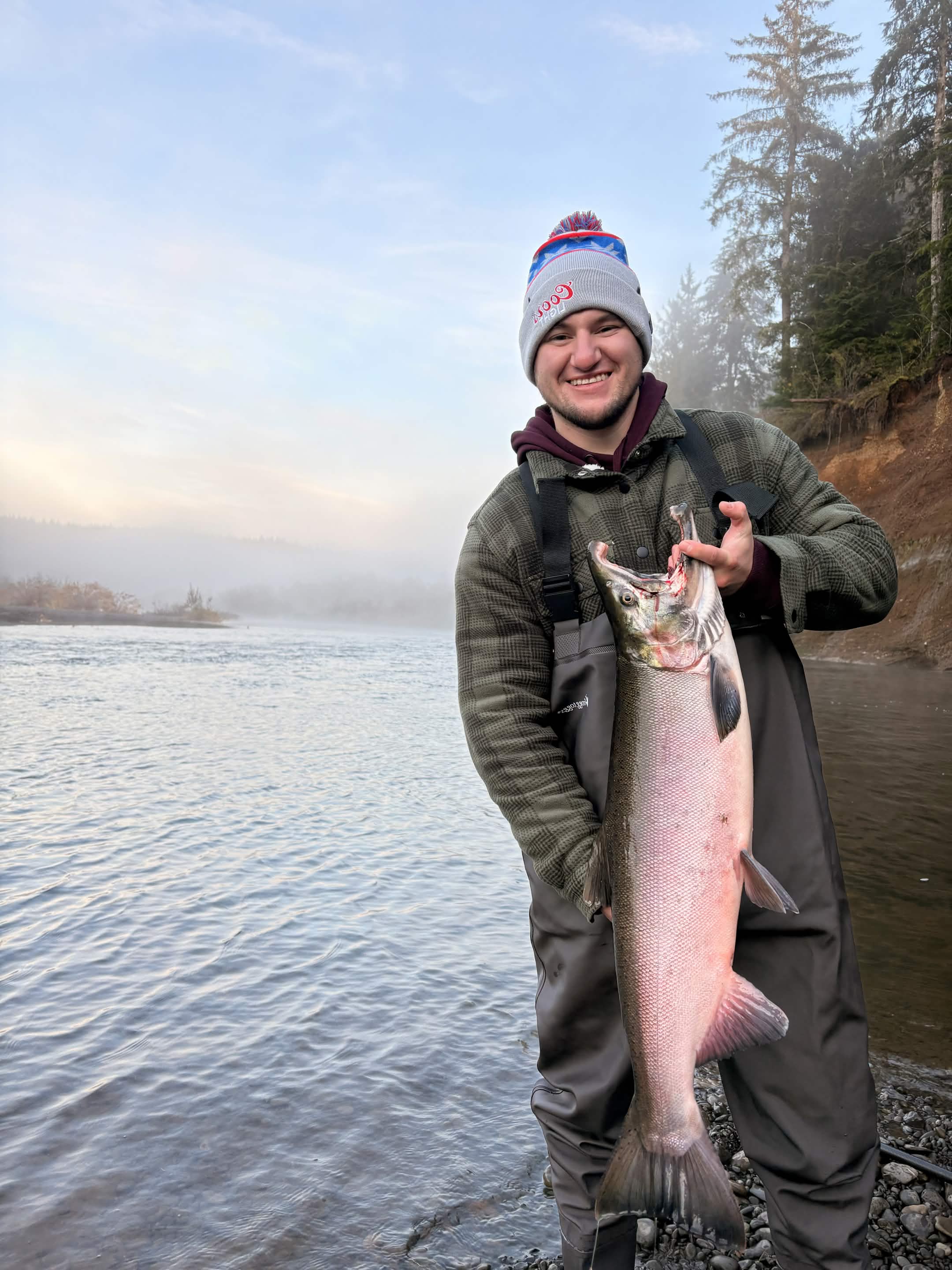 Angler holding a fish on a Washington river