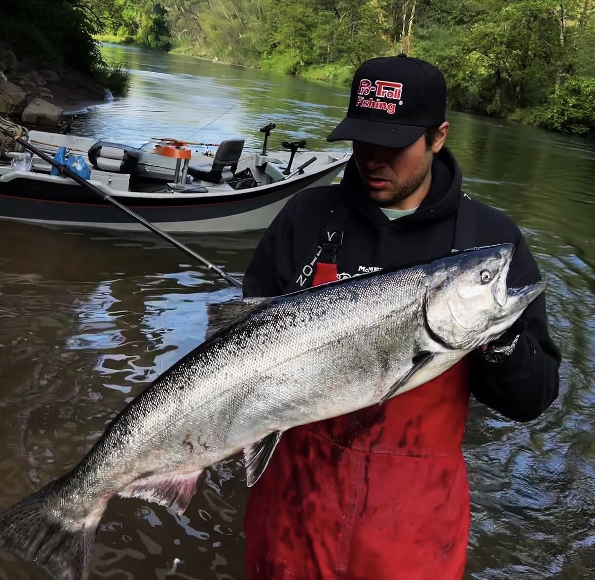 Two anglers on a drift boat with fall Chinook and coho salmon